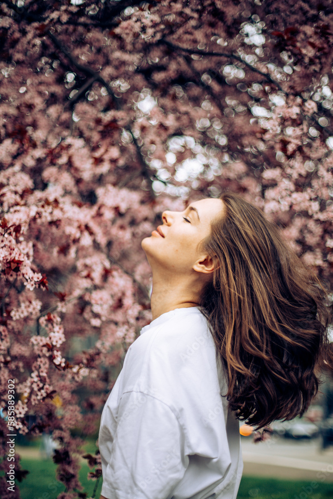 woman in a pink blooming garden woman in a pink blooming garden