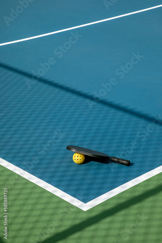 Pickleball Court with Paddle and Yellow Ball