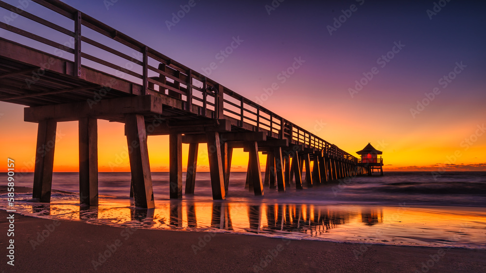 Perspective view of a wooden pier on the pond at sunset with perfectly specular reflection - Travel concept