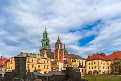 Historical Wawel Castle in Krakow, Poland on a spring day against a cloudy sky, a copy of the Wawel Castle in the foreground, European historical landmarks, tourist travel