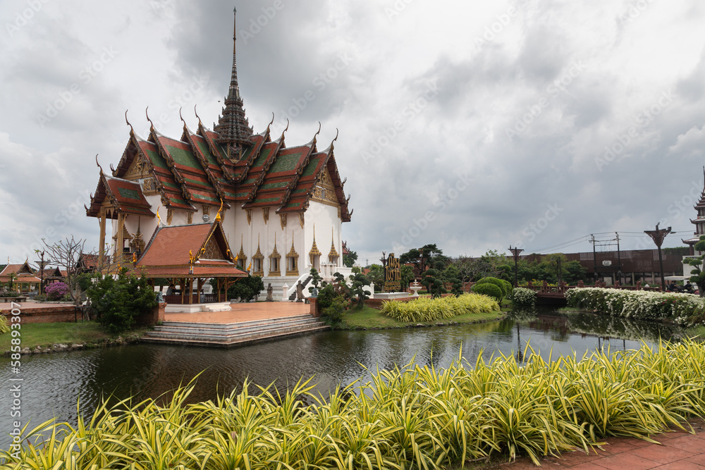 Panoramic photo of the architectural park of Oriental culture. Religious buildings of Thai history: palace and temple complexes. The exhibits are surrounded by ponds, tropical greenery and flowers