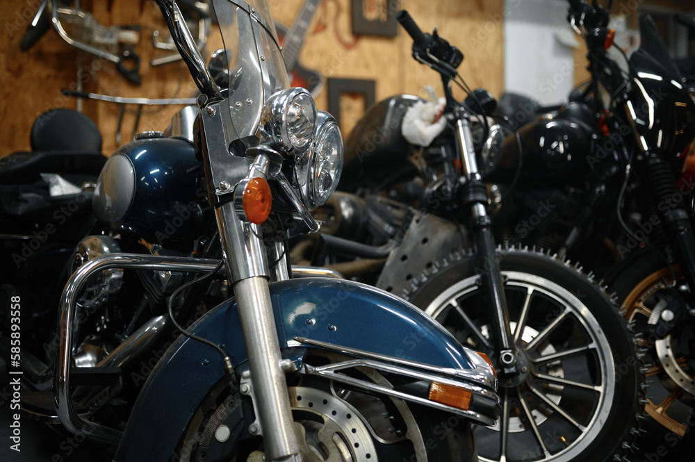 Motorcycles range in garage shop, repaired motorbikes ready for selling Motorcycles range in garage shop, repaired motorbikes ready for selling
