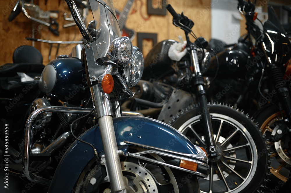 Motorcycles range in garage shop, repaired motorbikes ready for selling