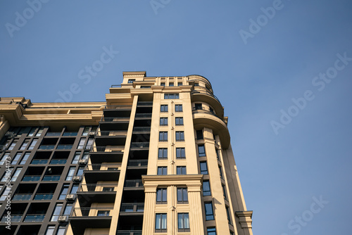 Facade of a multi-storey residential building against the sky, modern architecture, residential building.