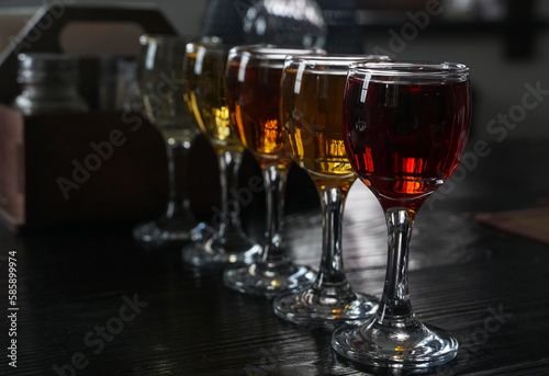 Glasses with wine. Different types of wine are poured into glasses. A set of alcoholic drinks in a restaurant.
