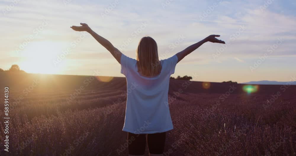 Dreamy woman walks and raise hands in lavender fields at sunrise. Peaceful surroundings bring her inner peace, and love for nature. Meditational concept. Model or blogger in Provence. Dreamy woman walks and raise hands in lavender fields at sunrise. Peaceful surroundings bring her inner peace, and love for nature. Meditational concept. Model or blogger in Provence.