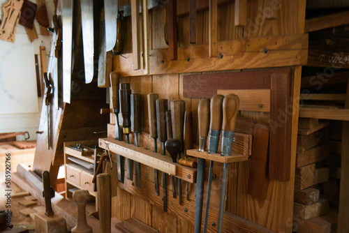 Woodworking hand tools in a rack in a cabinet makers shop.