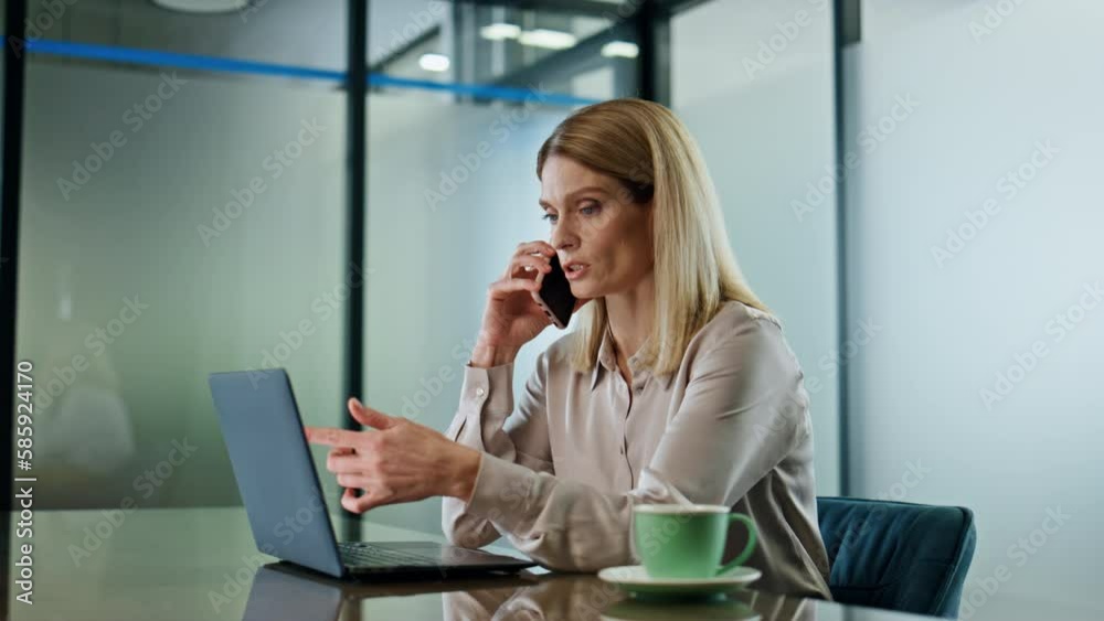 Serious executive calling phone office closeup. Businesswoman talking cellphone Serious executive calling phone office closeup. Businesswoman talking cellphone