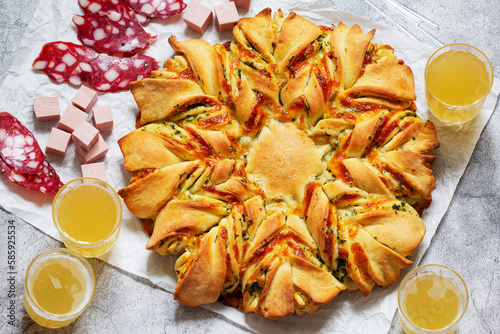 Obraz na płótnie Table for a friendly party, snack star bread with cheese filling, sausage and beer. w salonie