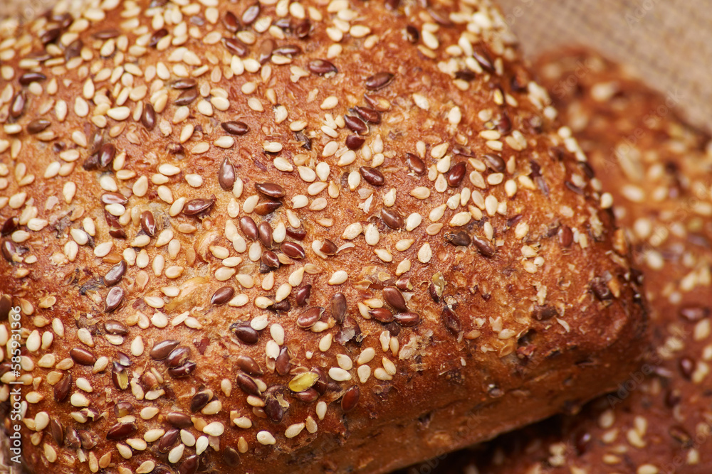 Two freshly baked rustic square shaped bread buns with sesame seeds extremely close up high detail view Two freshly baked rustic square shaped bread buns with sesame seeds extremely close up high detail view