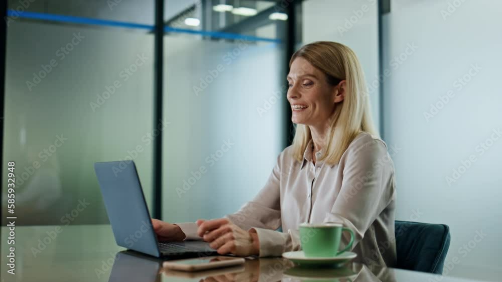 Smiling woman greeting at video chat in office close up. Happy director waving Smiling woman greeting at video chat in office close up. Happy director waving