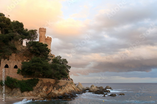 ancient fortress with towers on a rocky seashore  low clouds  rocks  seascape