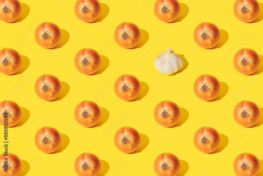 Onion and white onion on a yellow background. Minimal design and pattern. Onion and white onion on a yellow background. Minimal design and pattern.
