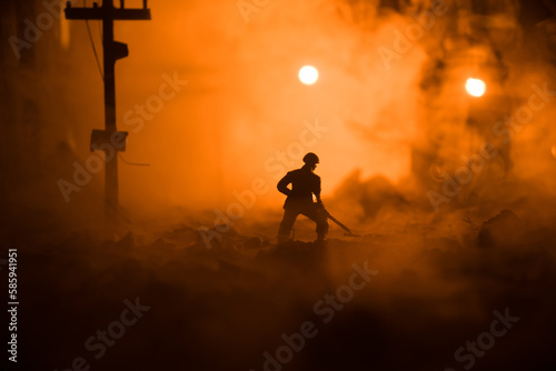 War Concept. Military silhouettes fighting scene on war fog sky background. Sappers clears mines at the site of recent fighting zone. Battle in ruined city.