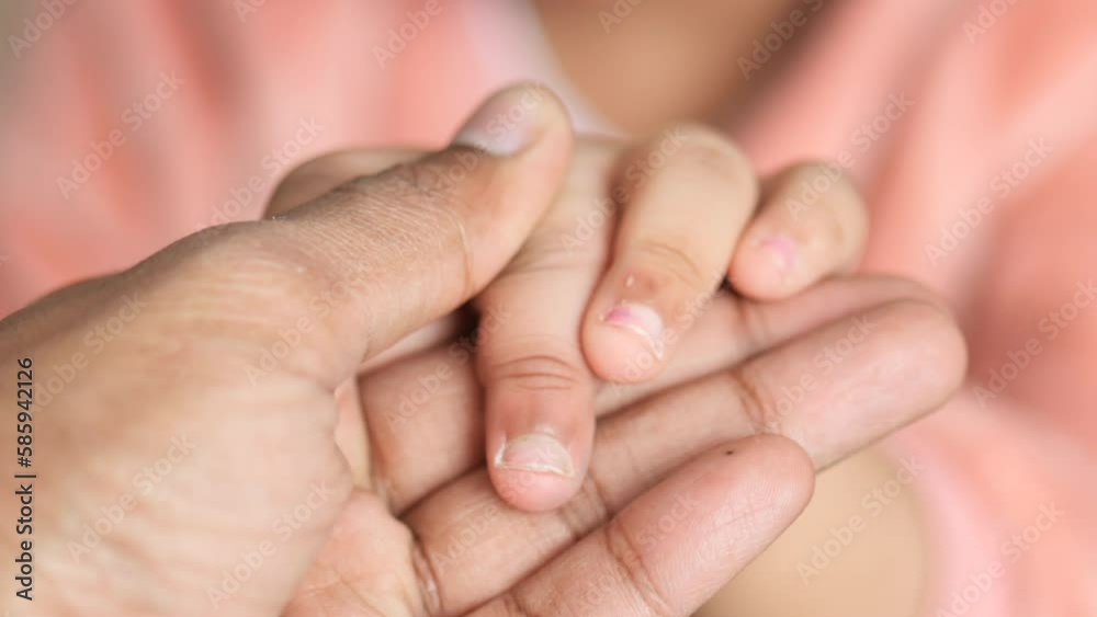 father holding hand of baby child, close up . father holding hand of baby child, close up .