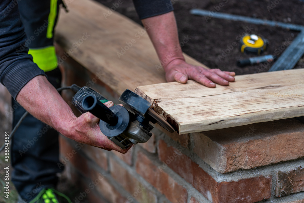 A carpenter works in a garden.