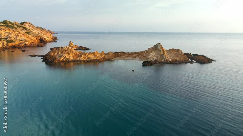 Sunset giving off golden glow against the rocks along the coastline of Spain Sunset giving off golden glow against the rocks along the coastline of Spain