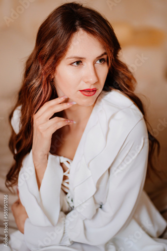 portrait of a beautiful woman in a white sexy dress with lacing and ruffles