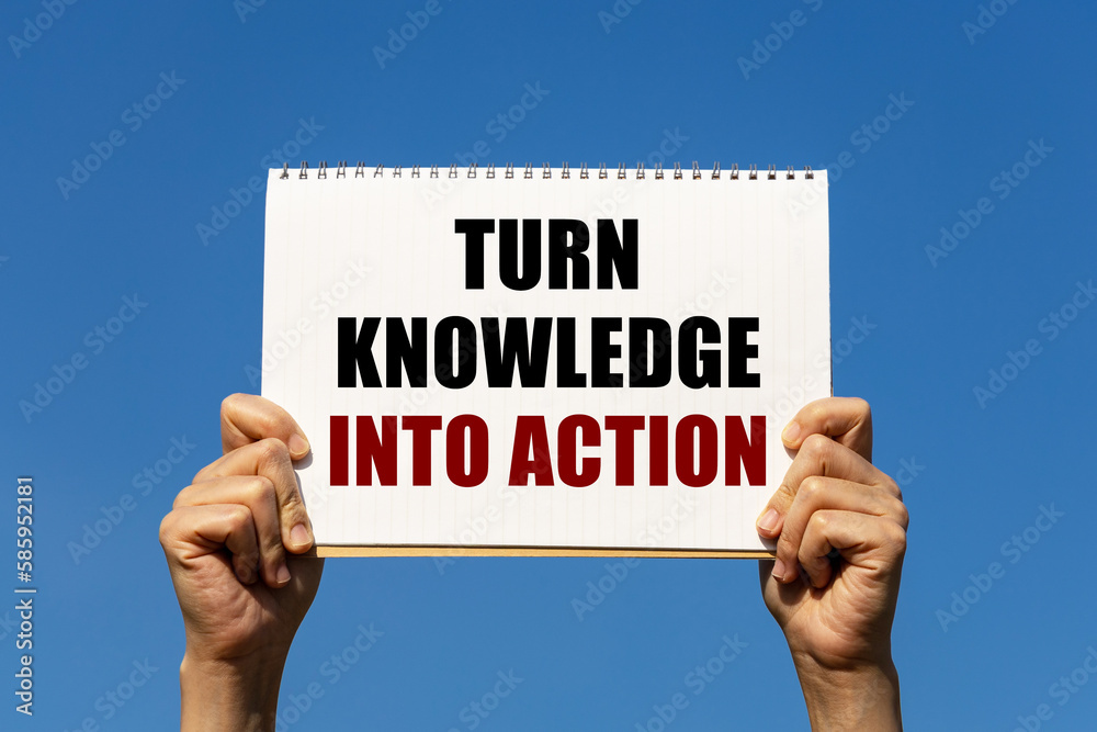 Turn knowledge into action text on notebook paper held by 2 hands with isolated blue sky background. This message can be used as business concept about turning knowledge into action. Turn knowledge into action text on notebook paper held by 2 hands with isolated blue sky background. This message can be used as business concept about turning knowledge into action.