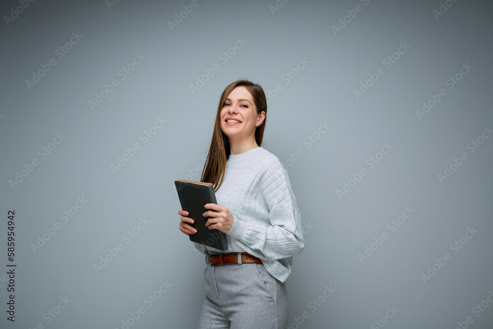 Smiling female teacher or young business woman holding book isolated portrait.