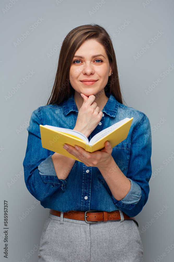 Thinking smiling woman teacher or student girl with yellow book. Thinking smiling woman teacher or student girl with yellow book.