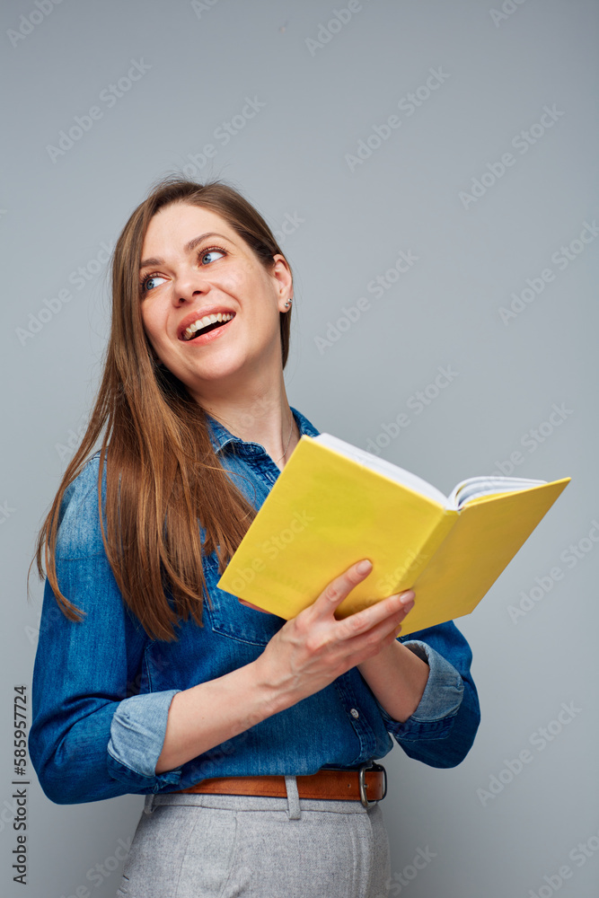 Smiling woman reading open yellow book. Smiling woman reading open yellow book.