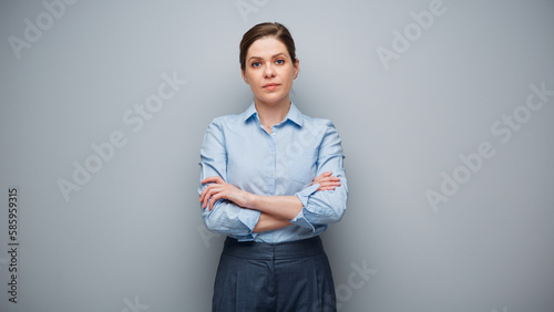 Portrait of serious business woman on gray wall background.