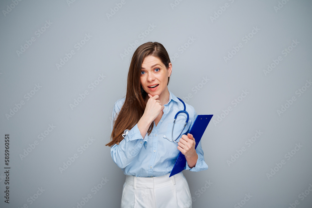 Smiling thinking doctor woman isolated portrait with copy space. Smiling thinking doctor woman isolated portrait with copy space.