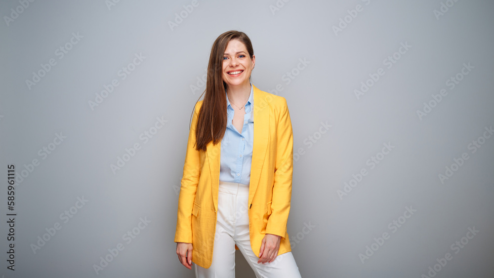 Smiling happy woman in yellow business suit on gray background Smiling happy woman in yellow business suit on gray background