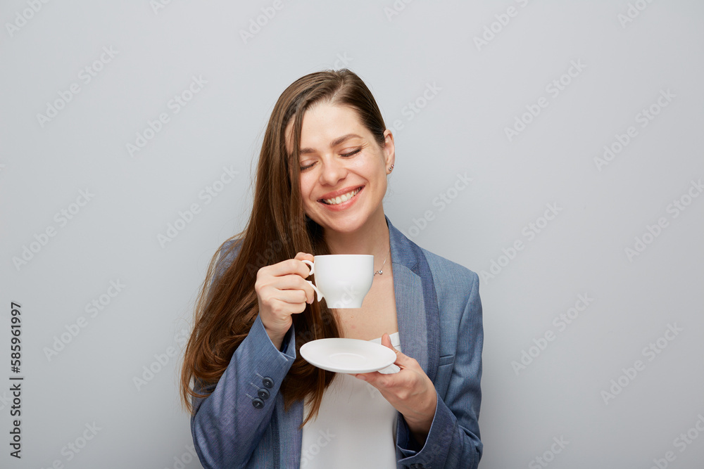 Business woman with closed eyes wearing suit drinking coffee. Business woman with closed eyes wearing suit drinking coffee.