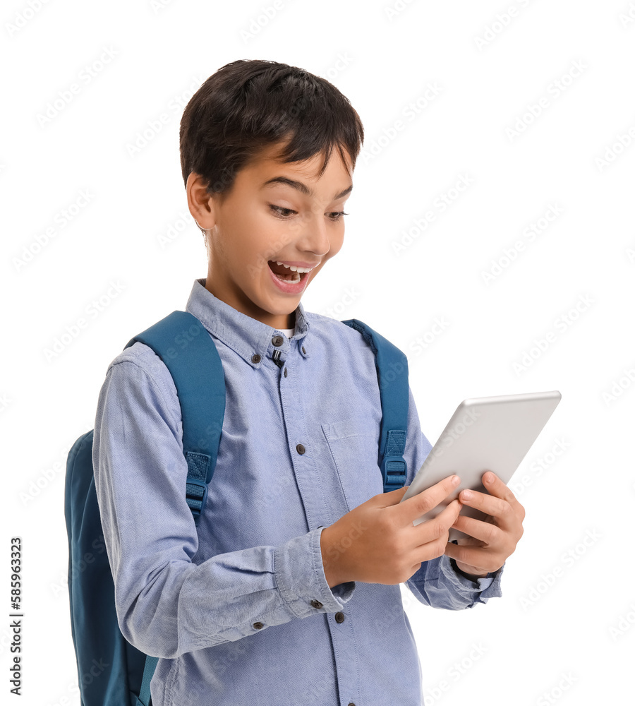 Surprised little schoolboy using tablet computer on white background Surprised little schoolboy using tablet computer on white background
