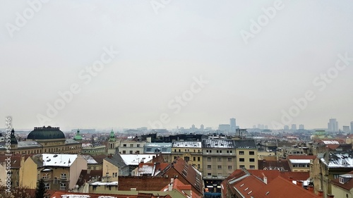 Snowy cityscape of Zagreb on an overcast day with light smog, Croatia