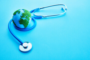 World Health Day. Global Health Awareness Concept. Globe and Stethoscope on blue background.