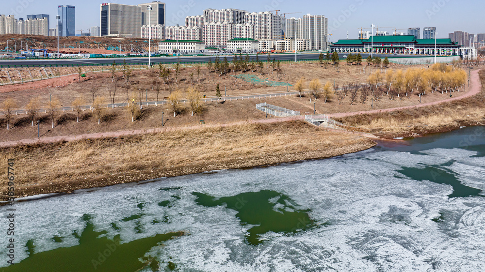 Landscape along the Yitong River in Changchun, China with melting ice and snow