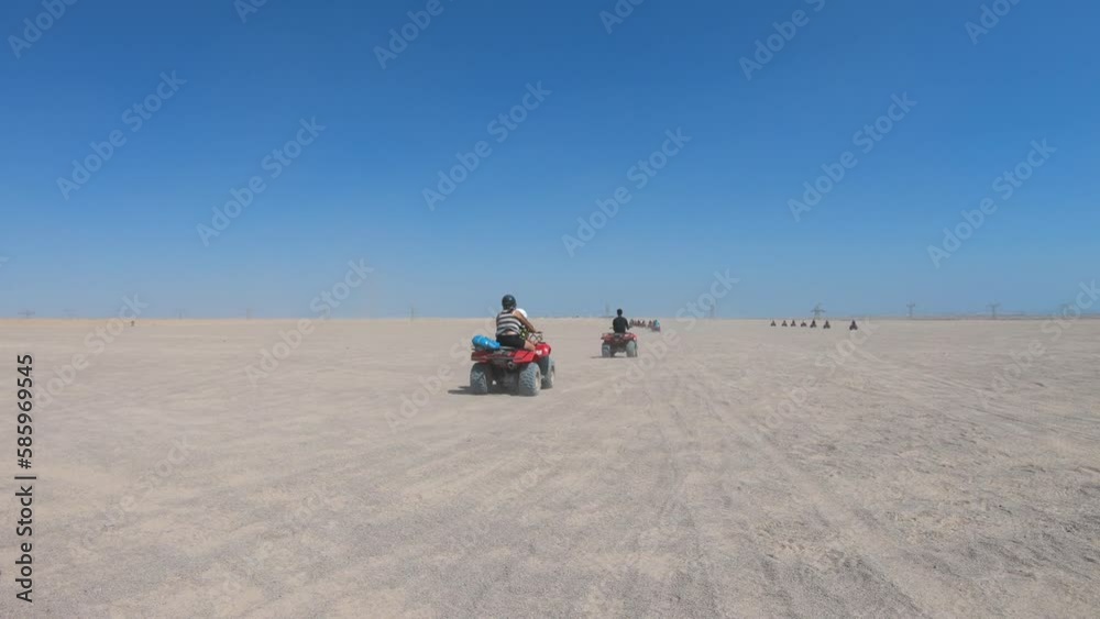 Cairo, Egypt - 13 September, 2019: Tourists riding on a quad bikes during safari in the desert near Hurghada, Egypt. Cairo, Egypt - 13 September, 2019: Tourists riding on a quad bikes during safari in the desert near Hurghada, Egypt.