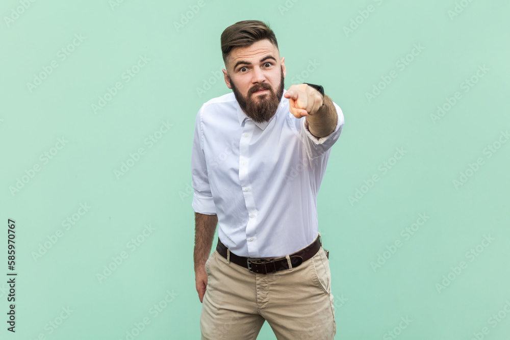 Fototapeta premium Businessman looking at camera with serious expression, pointing at you, expressing anger and hate.