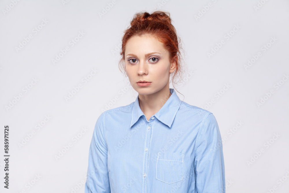 Sad unhappy upset redhead woman standing and looking at camera with dissatisfied sadness face. Sad unhappy upset redhead woman standing and looking at camera with dissatisfied sadness face.