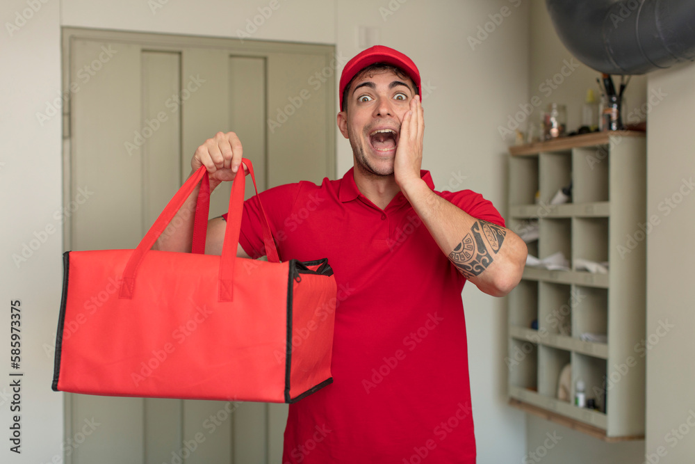 young handsome man feeling happy and astonished at something unbelievable. pizza delivery concept young handsome man feeling happy and astonished at something unbelievable. pizza delivery concept