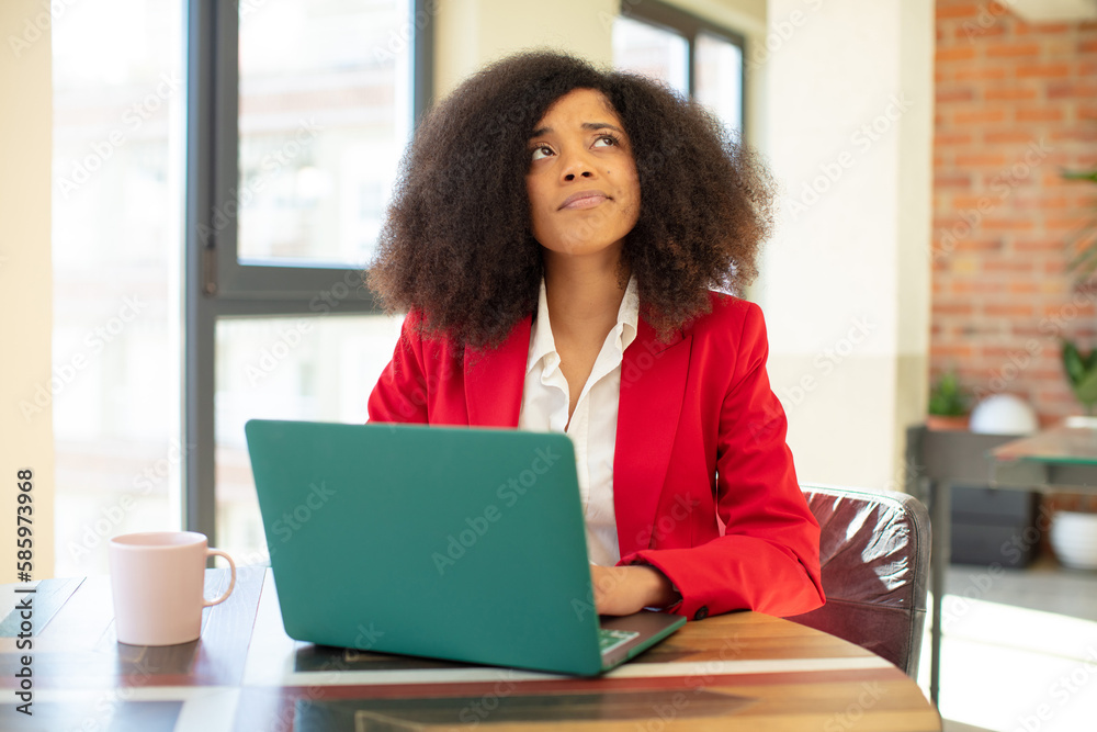 pretty afro black woman smiling with a happy, confident expression with hand on chin. businesswoman and laptop concept pretty afro black woman smiling with a happy, confident expression with hand on chin. businesswoman and laptop concept