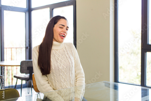 pretty caucasian woman with a big, friendly, carefree smile, looking positive, relaxed and happy, chilling