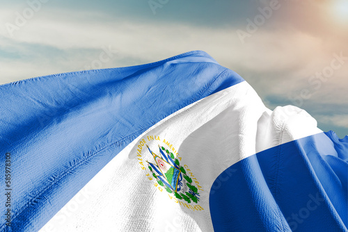 El Salvador national flag cloth fabric waving on beautiful grey sky.