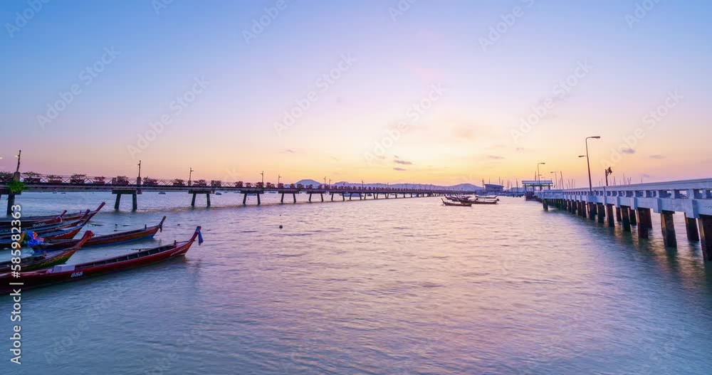 Time Lapse Chalong pier during sunrise or sunset Amazing beautiful colorful dramatic sky over sea in Phuket thailand.Beautiful light nature dramatic sky clouds flowing fast in the sky