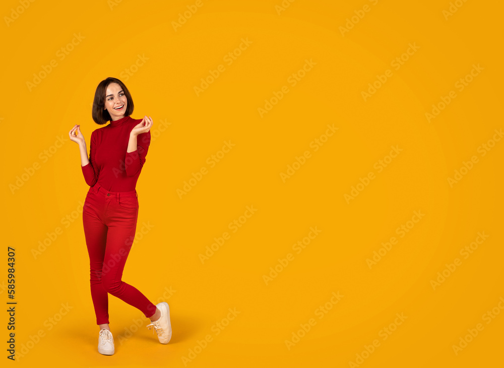 Excited young woman looking at copy space and gesturing Excited young woman looking at copy space and gesturing