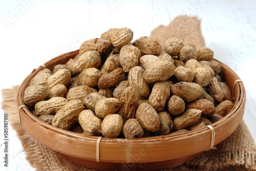 boiled peanuts in wooden plate ,on white background  photo