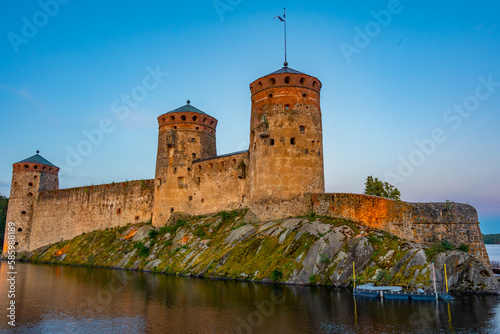 Sunset view of Olavinlinna castle in Savonlinna, Finland photo