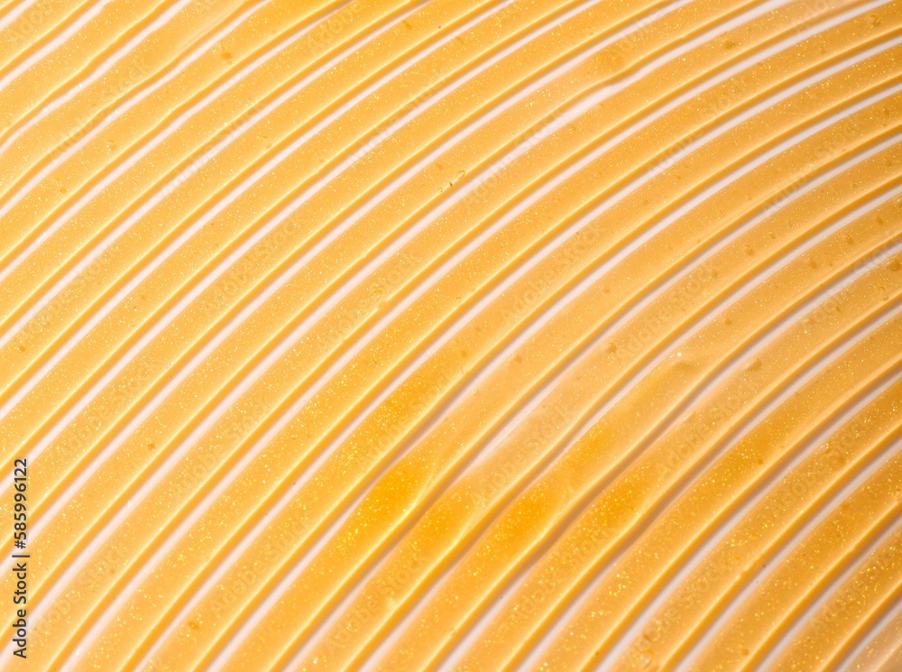Gold skincare slushed on a white background