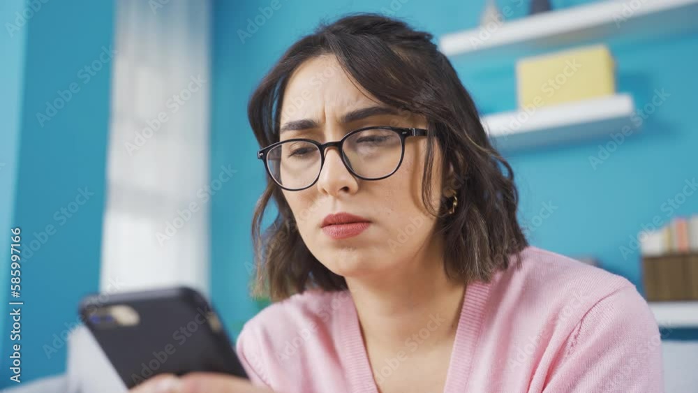 Frustrated young woman experiences disappointment.
The young woman using the phone at home is upset and frustrated by the bad notification.
Frustrated young woman experiences disappointment.
The young woman using the phone at home is upset and frustrated by the bad notification.