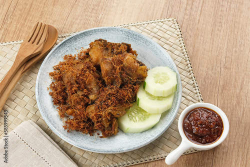 Ayam Goreng Lengkuas, fried chicken cooked with spices and sprinkled with grated galangal. Indonesian traditional food.  
 photo