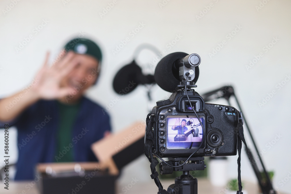 Potrait of excited content creator recording vlog shooting in home studio review product and giving explanation about the product. 