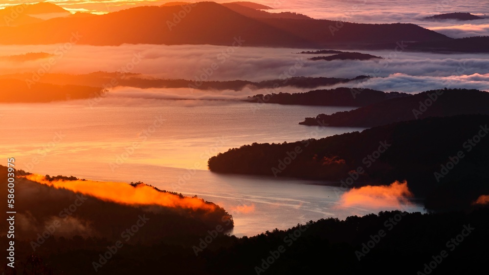 Aerial view of the fog over the rocky cost at sunset
